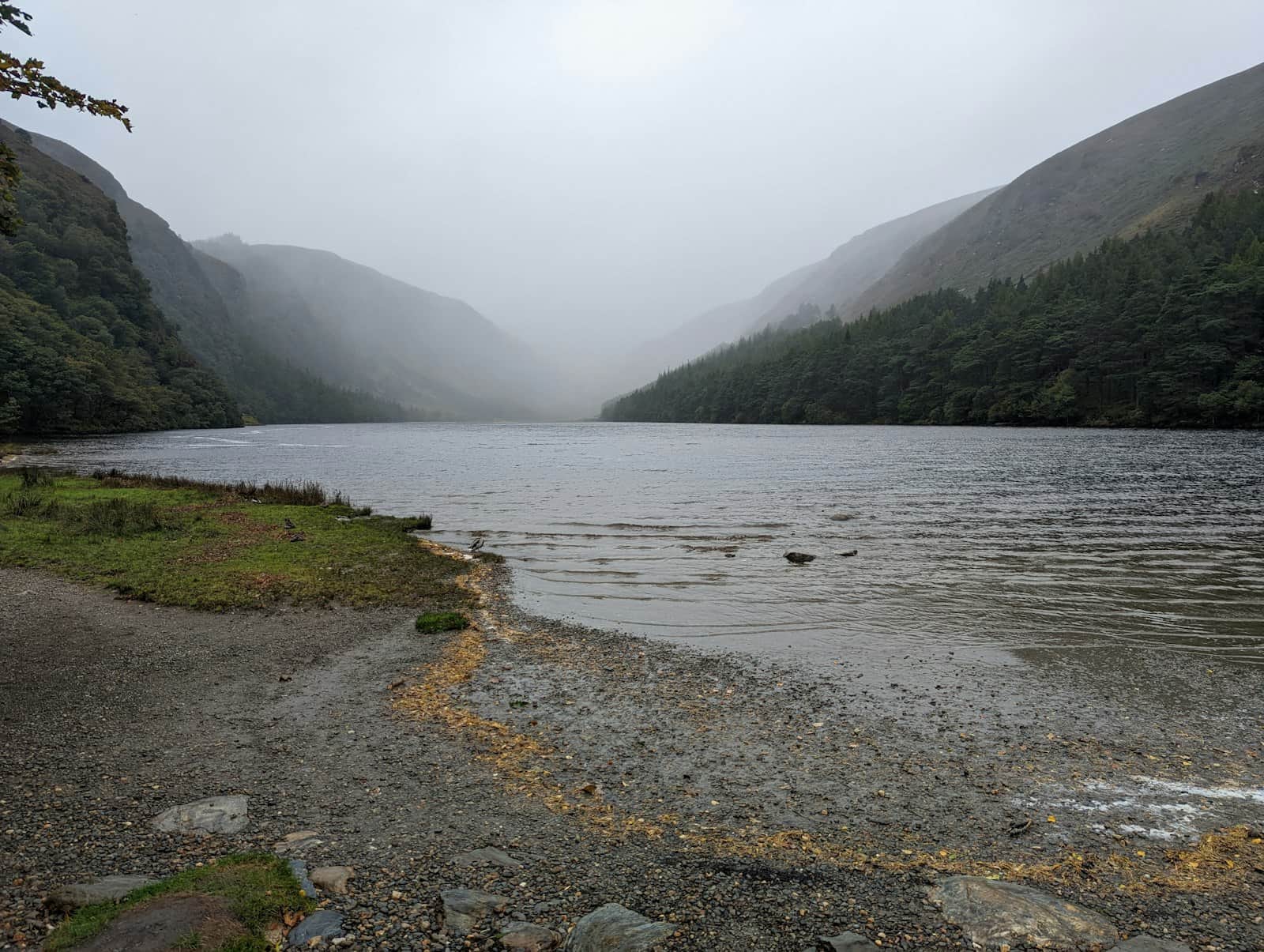 Serene green valley and round tower of Glendalough in the Wicklow Mountains near Dublin